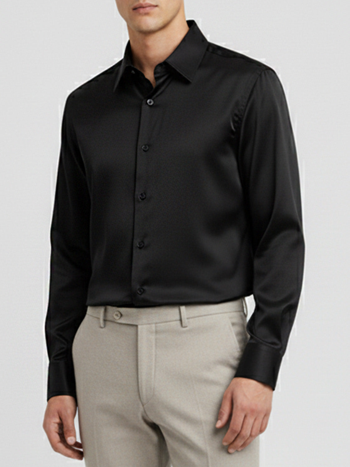 A classic black long-sleeved dress shirt with a pointed collar, shown on a mannequin.