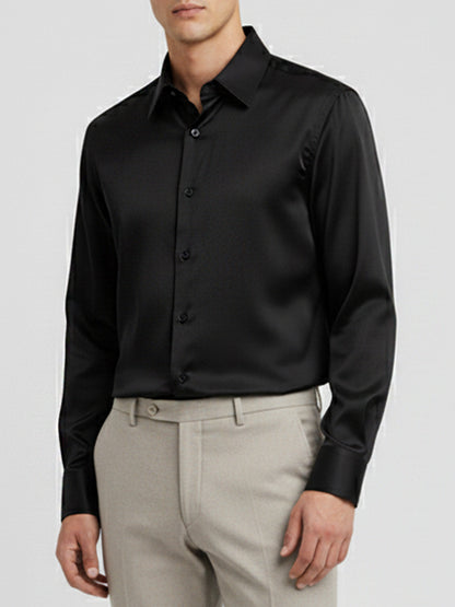 A classic black long-sleeved dress shirt with a pointed collar, shown on a mannequin.