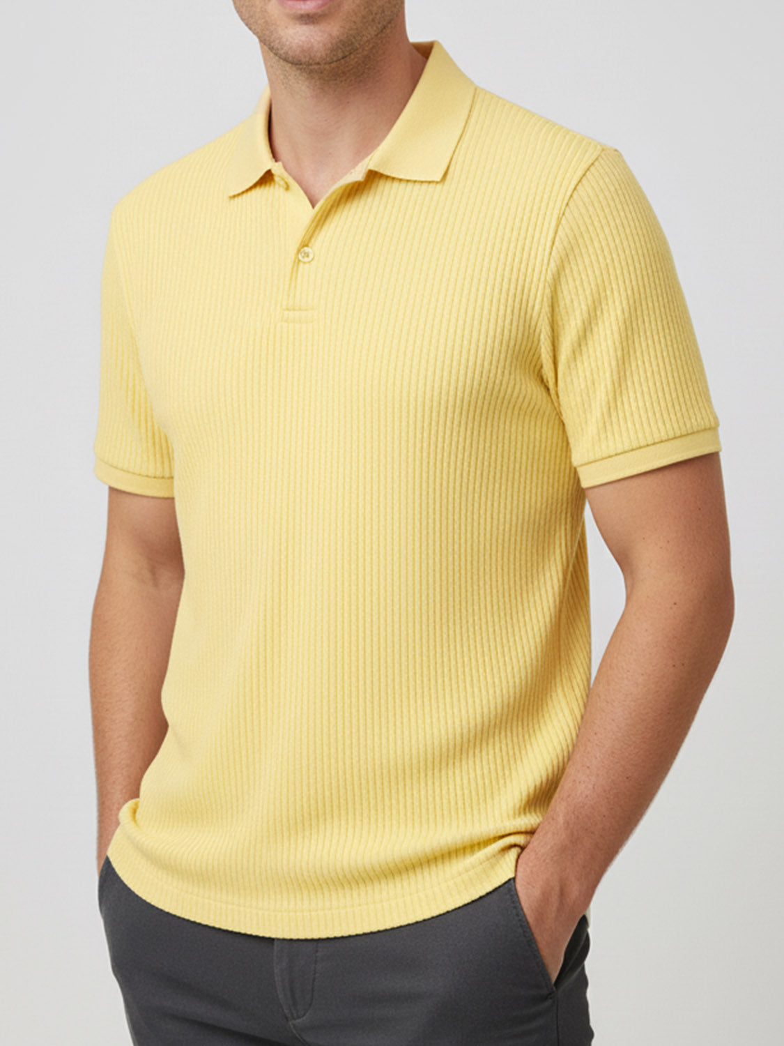 A sunny yellow short-sleeved polo shirt with a ribbed texture, a polo collar, and a two-button placket.
